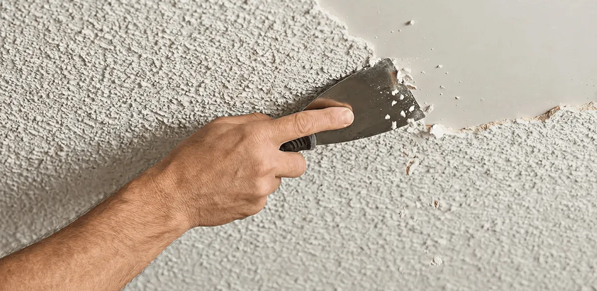 Popcorn ceiling removal scraping off textured ceiling finish in New Orleans, LA