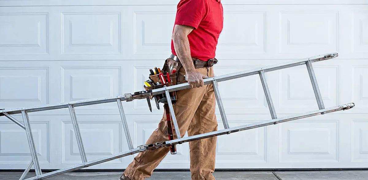 Garage door repair technician arriving with tools and ladder in New Orleans, LA