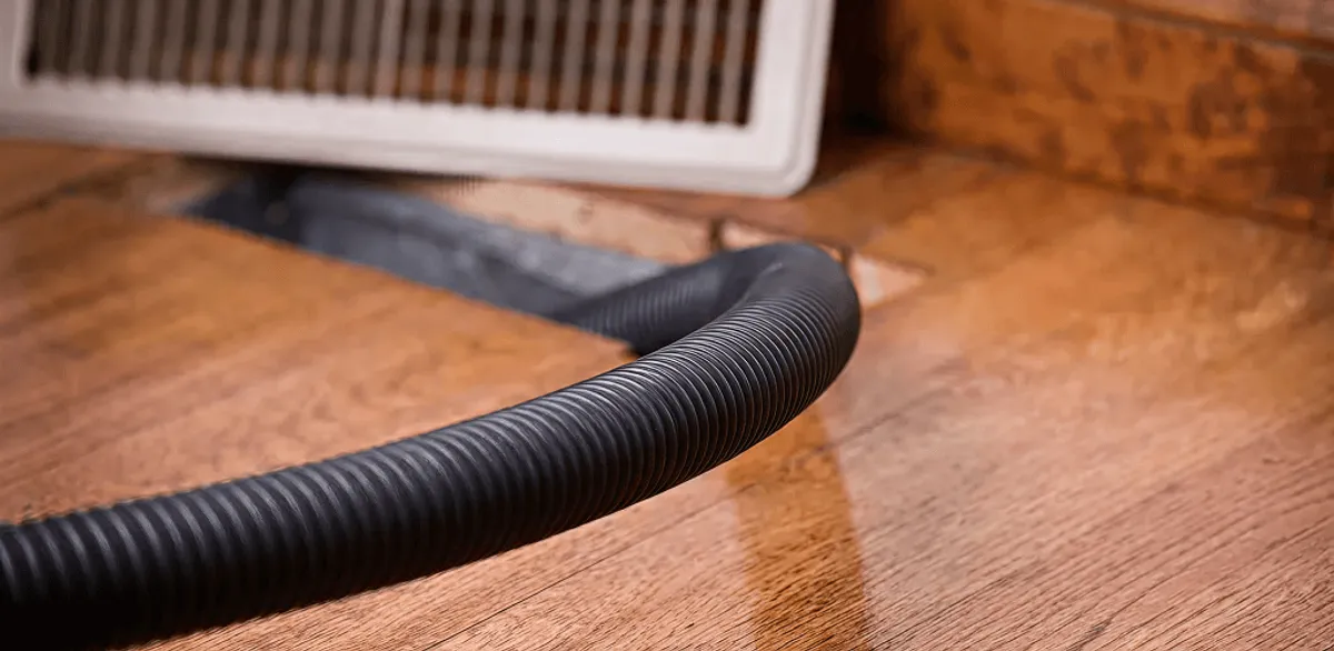 Air duct cleaning hose inserted into a floor vent for ductwork cleaning in New Orleans, LA