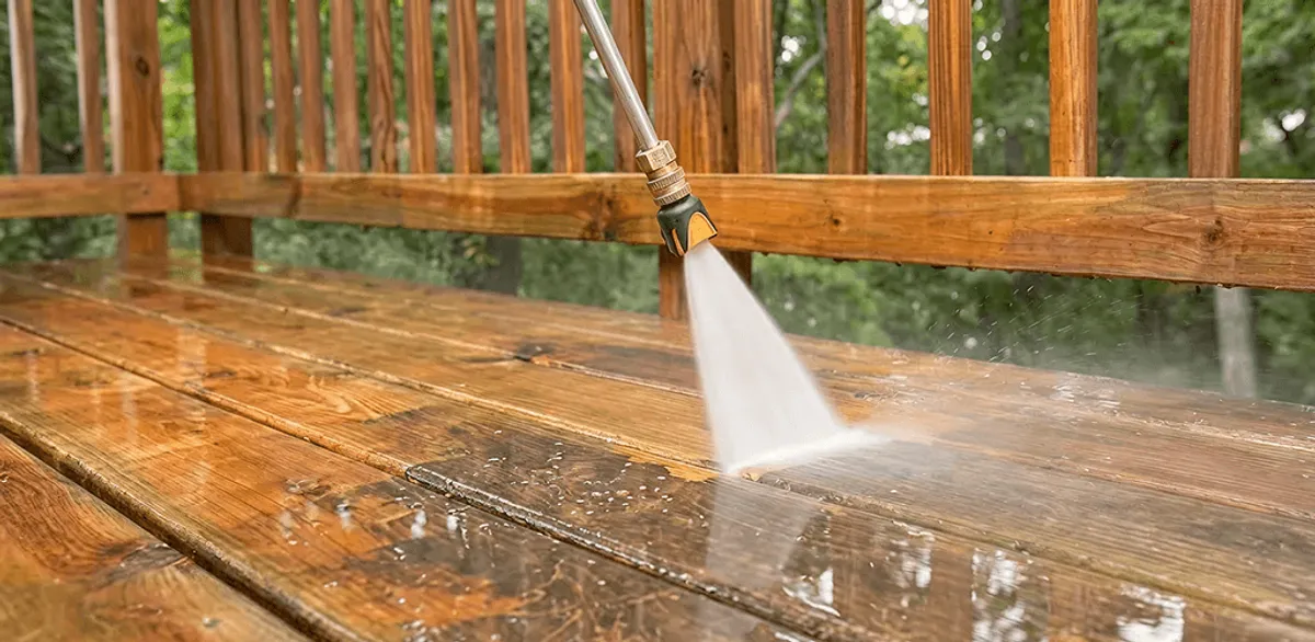 Pressure washing a wood deck to remove dirt and buildup in New Orleans, LA