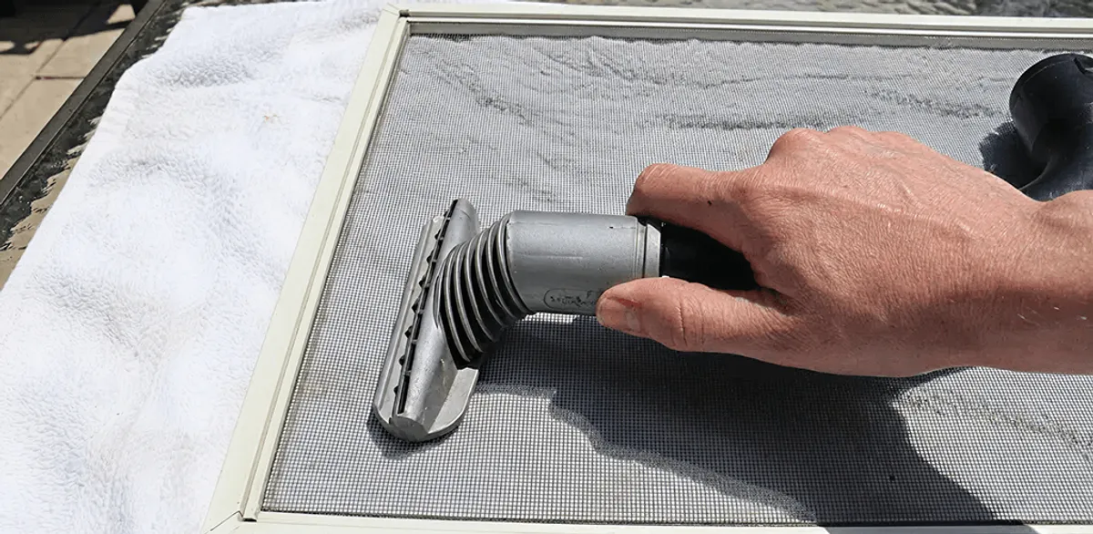 Window screen repair cleaning and fixing a damaged screen mesh in New Orleans, LA